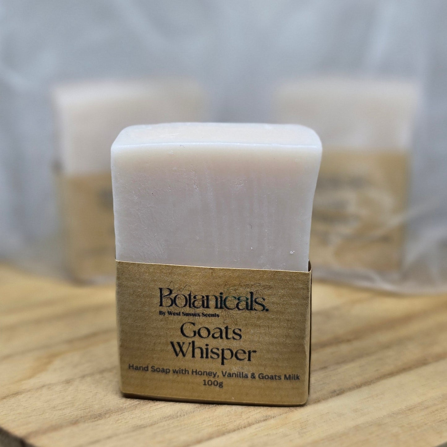 Bar of soap on a wooden soap dish with a blurred background